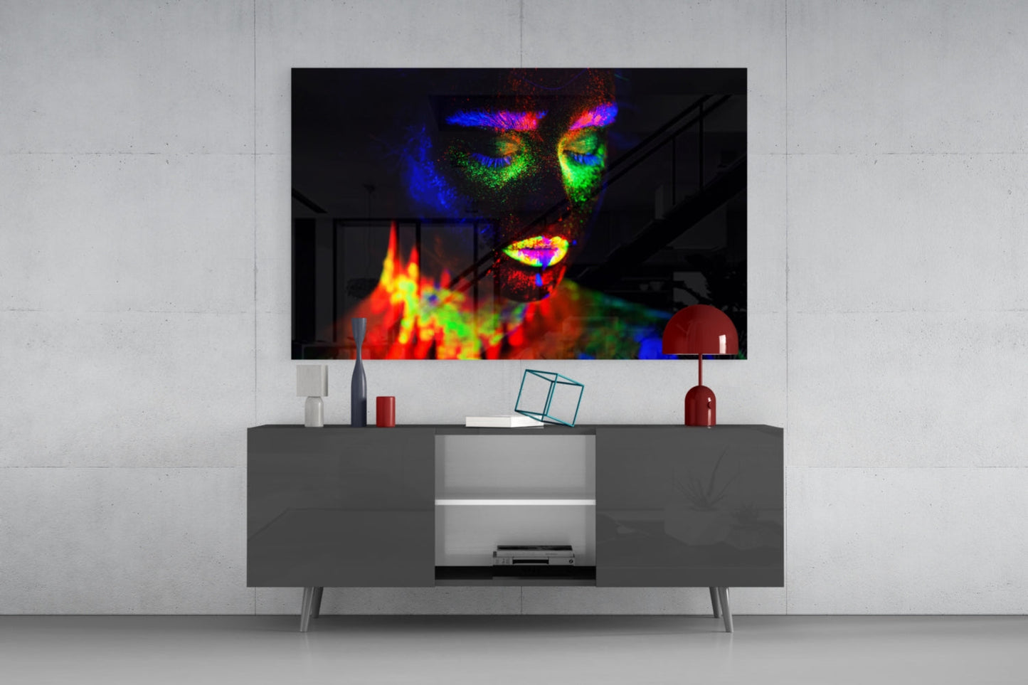 Colorful neon portrait glass art featuring a woman's face with vibrant rainbow hues displayed on living room wall above gray media console.