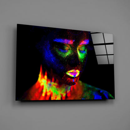 Angled view of neon-colored abstract female portrait on black glass panel with white grid pattern visible on right edge.