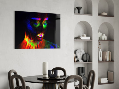 Vibrant neon portrait glass art displayed above a dining table in a modern interior setting.