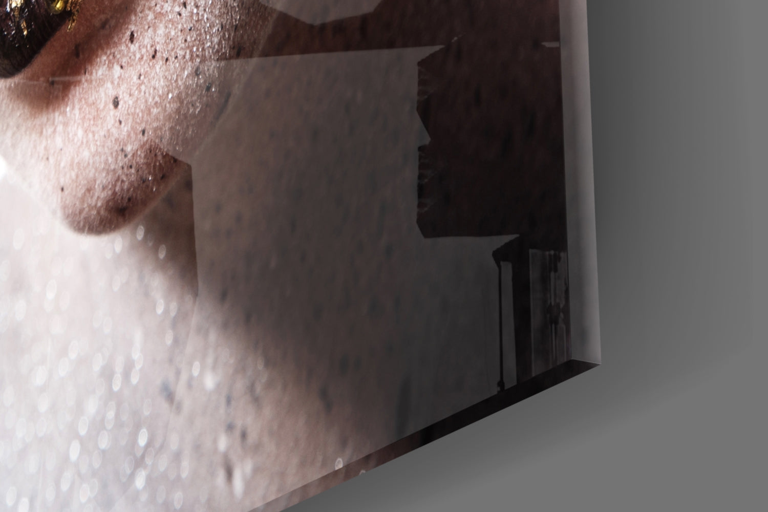 Close-up side view of frosted glass wall art featuring a woman's face with water droplets and textured surface details.