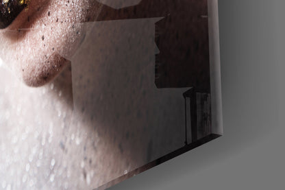Close-up side view of frosted glass wall art featuring a woman's face with water droplets and textured surface details.