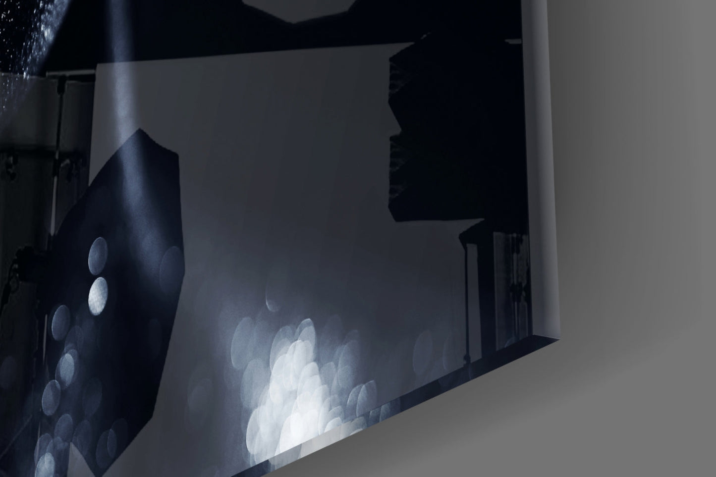 Close-up angled view of frosted glass wall art displaying a female portrait with blue and white tones against darker background.