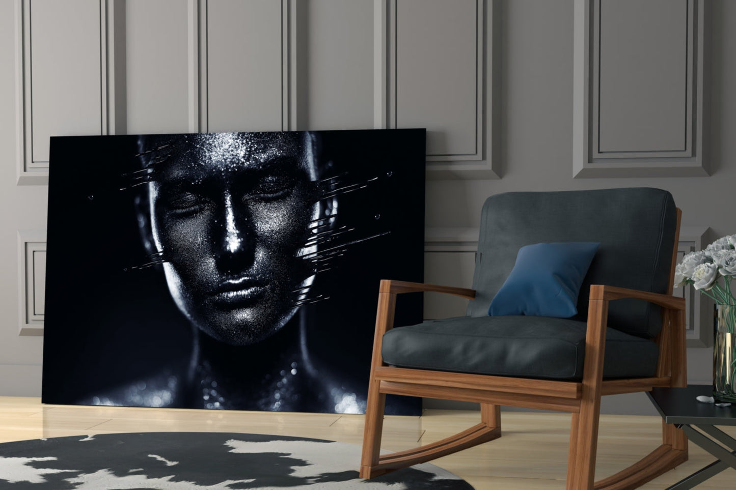 Black and white glass portrait of a woman's face with glitter detail, displayed in a modern living room next to a wooden chair.