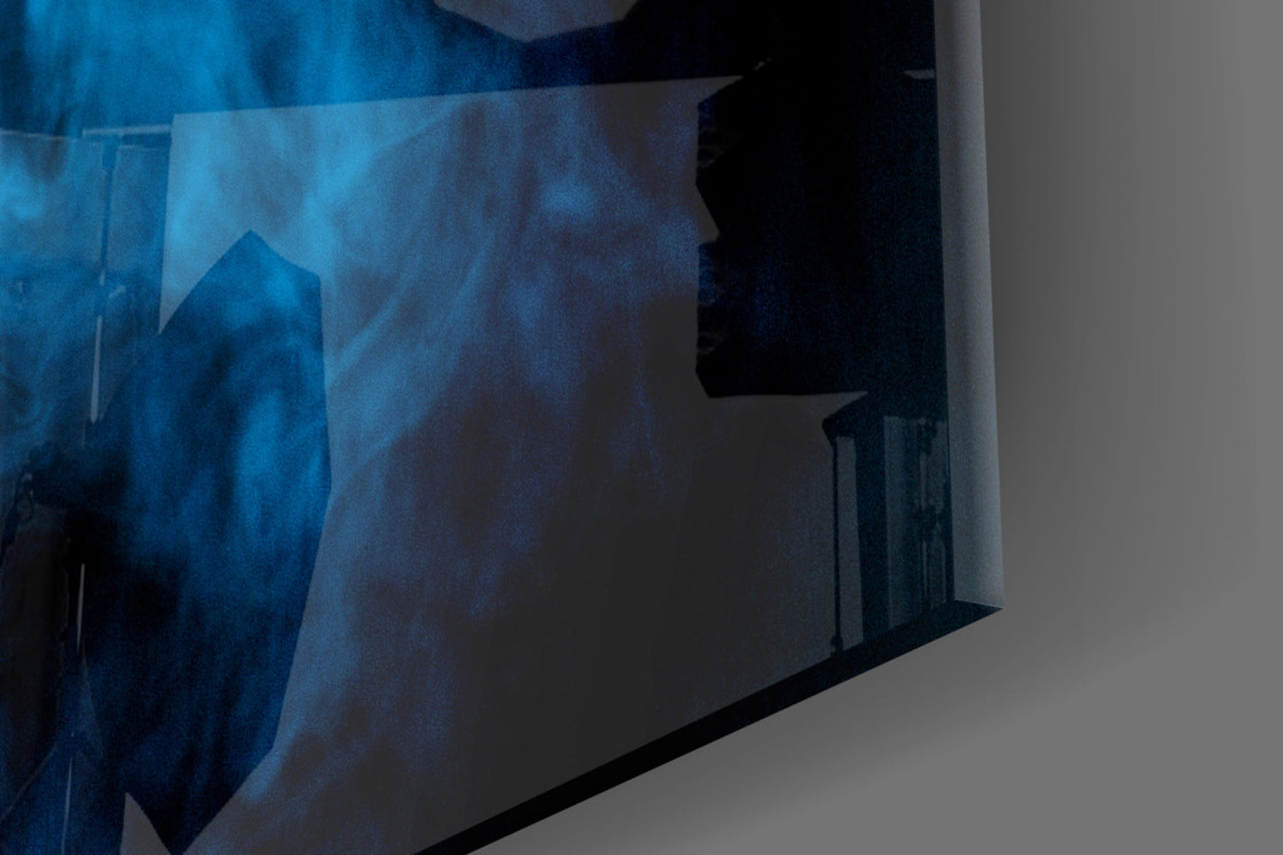 Blue smoke glass wall art panel displayed at an angle, showing deep blue swirling patterns with black silhouettes against white background.