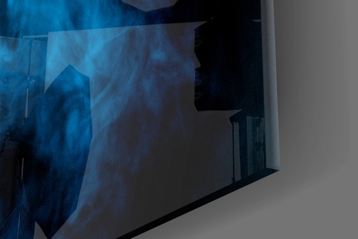 Blue smoke glass wall art panel displayed at an angle, showing deep blue swirling patterns with black silhouettes against white background.