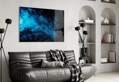 Blue smoke abstract glass wall art displayed above black leather sofa in modern living room interior.