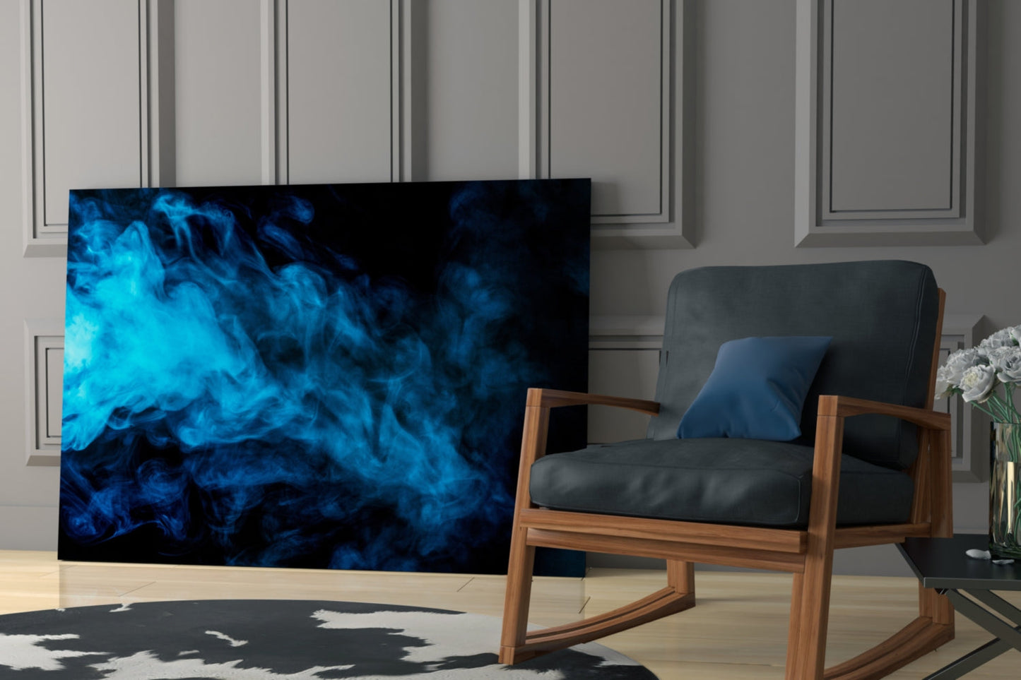 Blue Smoke Glass Wall Art displayed on floor leaning against wall in modern living room with wooden chair and white flowers.