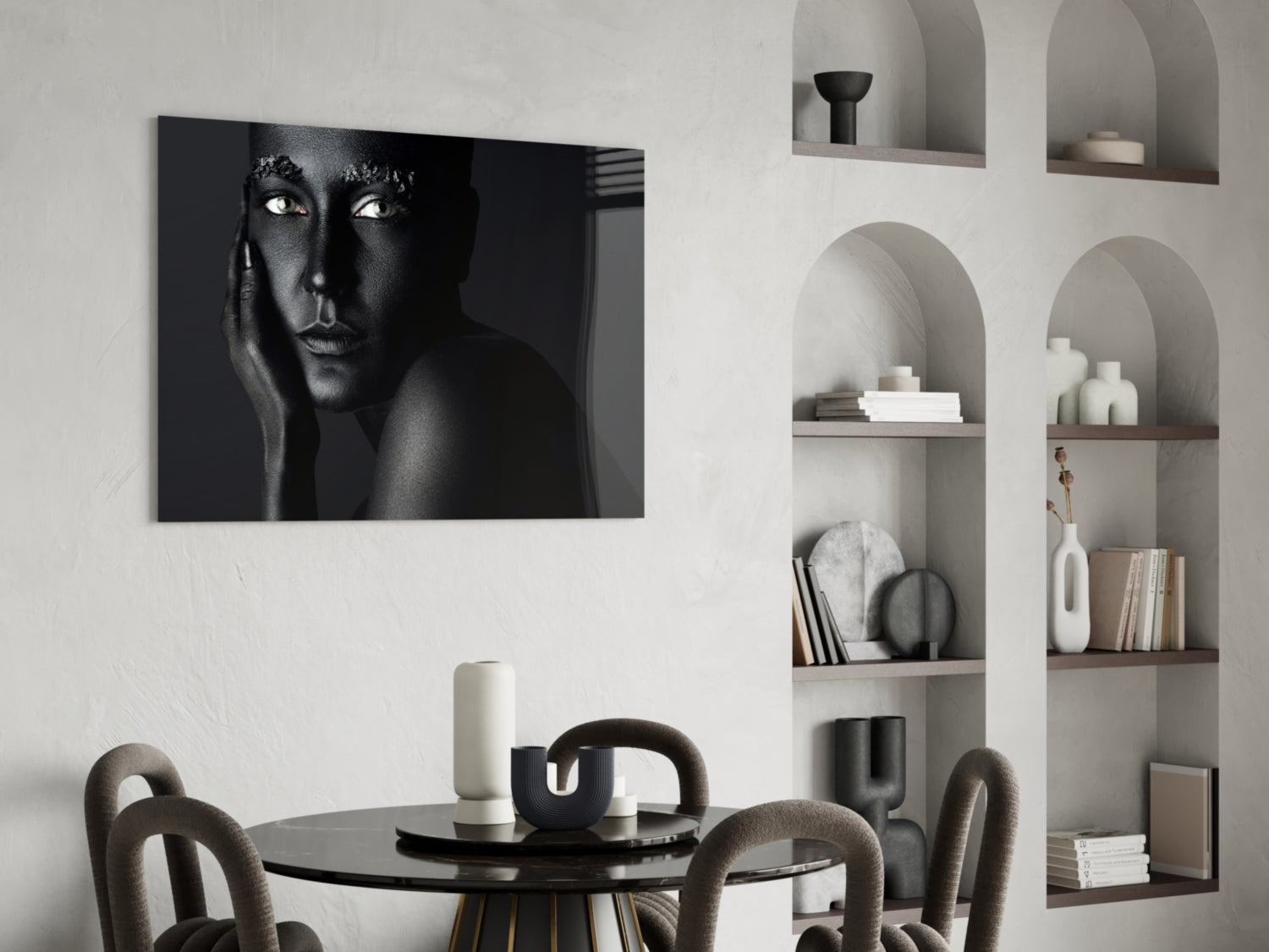 Black and white portrait of woman's face with striking eyes displayed on glass above dining table in modern interior.