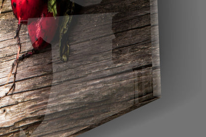 Glass wall art with red carrot and green radish designs displayed against rustic wooden plank background.
