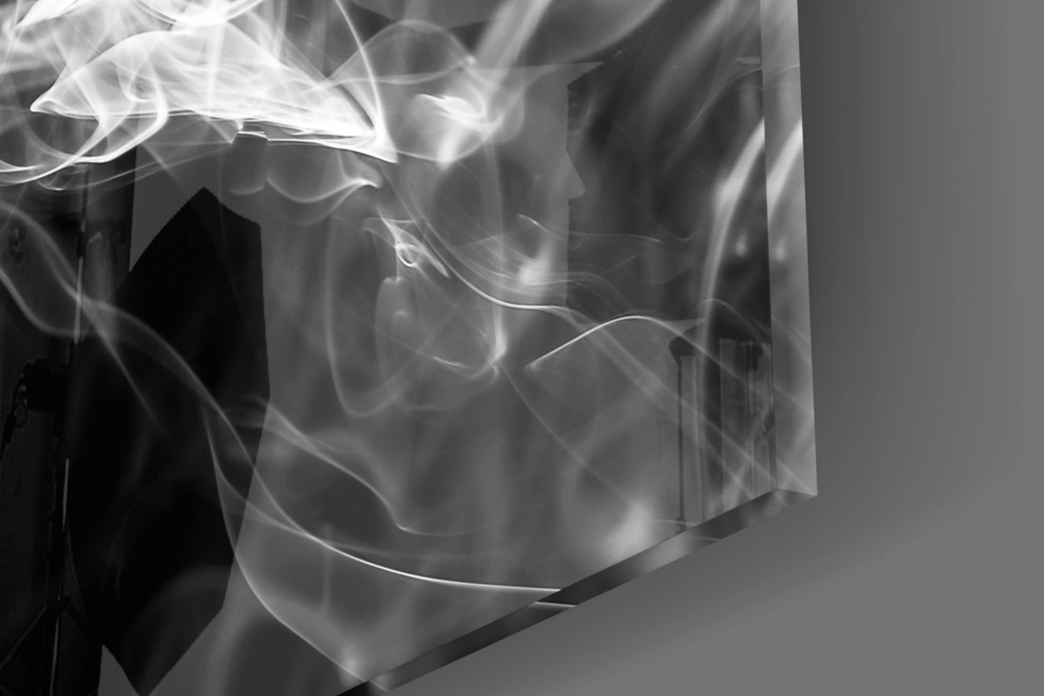 Close-up detail of white smoke patterns swirling within translucent glass, photographed against neutral gray background.
