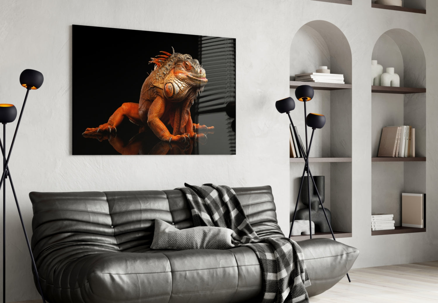 Komodo dragon glass wall art displaying an orange reptile on black background, hung above a gray leather sofa in a modern living room.
