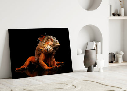 Orange and red Komodo dragon glass art leaning against white wall in minimalist interior setting.