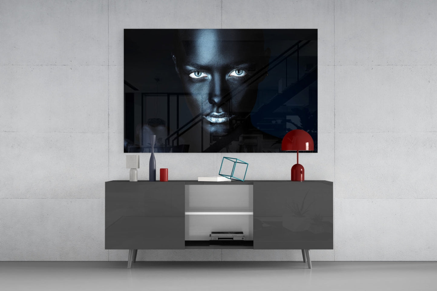 Modern living room with dark TV stand displaying glass wall art of woman's face with striking blue eyes against dark background.