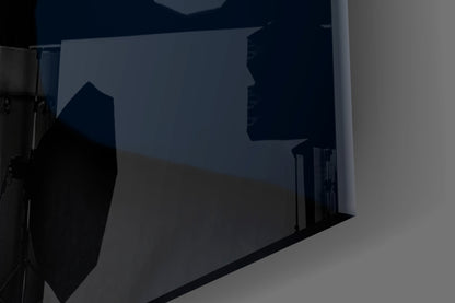 Silhouetted woman's profile etched into frosted glass panel mounted on white wall, photographed at angle.