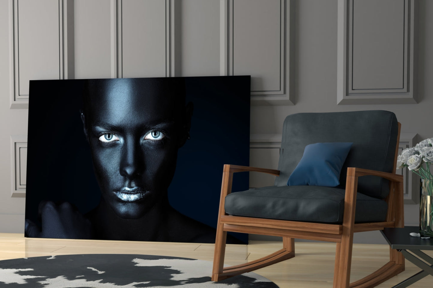 Black glass wall art featuring a woman's face with striking white eyes against dark skin, displayed in a modern living room setting.