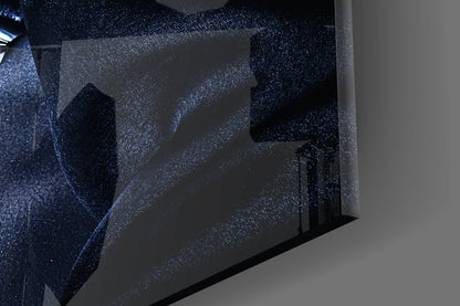 Close-up angled view of sparkling dark blue glass wall art with silver glitter texture and silhouetted portrait profile.