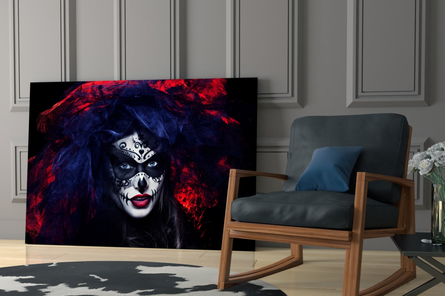 Glass wall art depicting woman with skeletal face paint, red and blue hair, displayed in modern living room beside wooden chair.