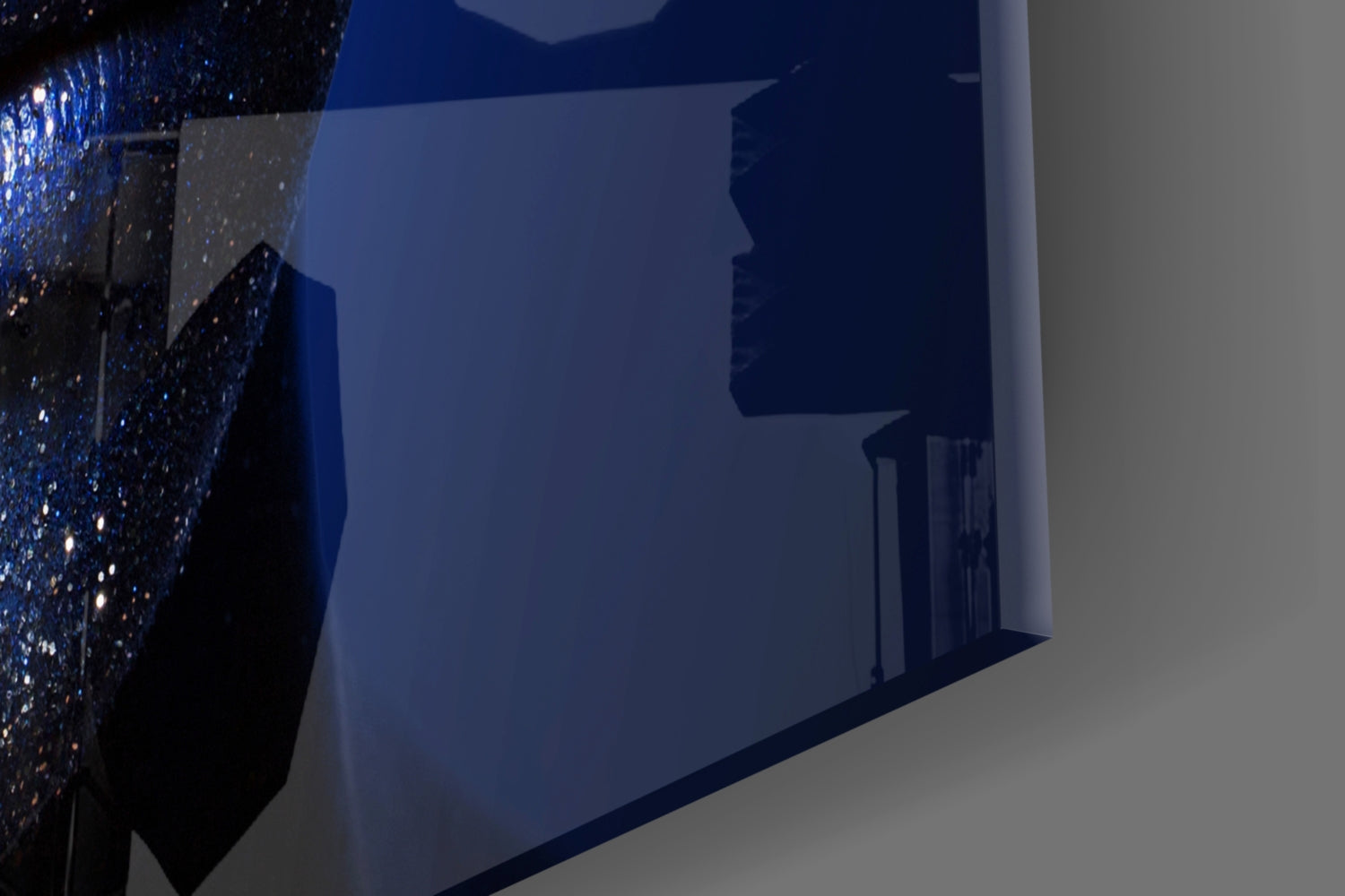Blue-tinted interior display of glass wall art featuring a woman's profile silhouette with sparkling textured detail on left edge.