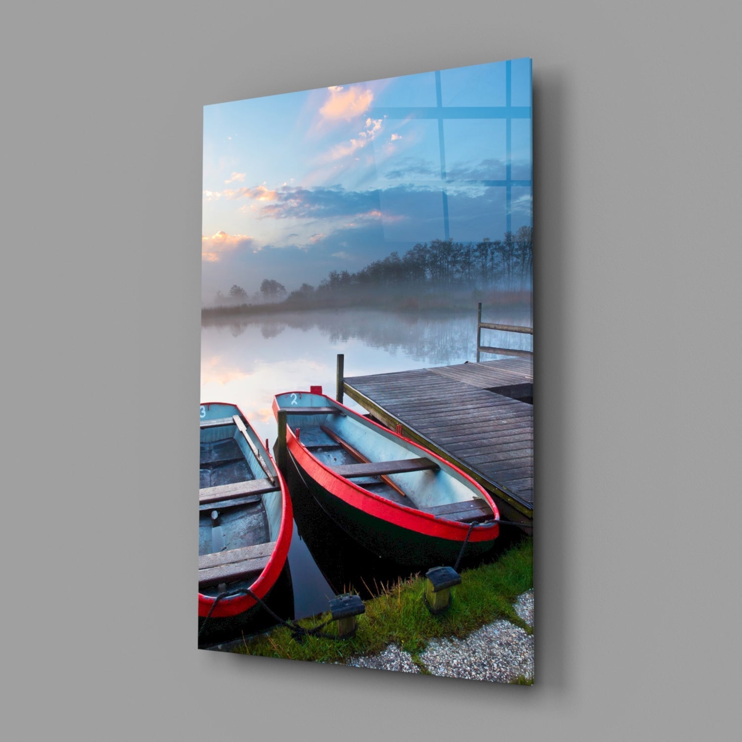 Red and blue rowboats moored at a wooden dock beside a misty lake at sunset, displayed as glass wall art.
