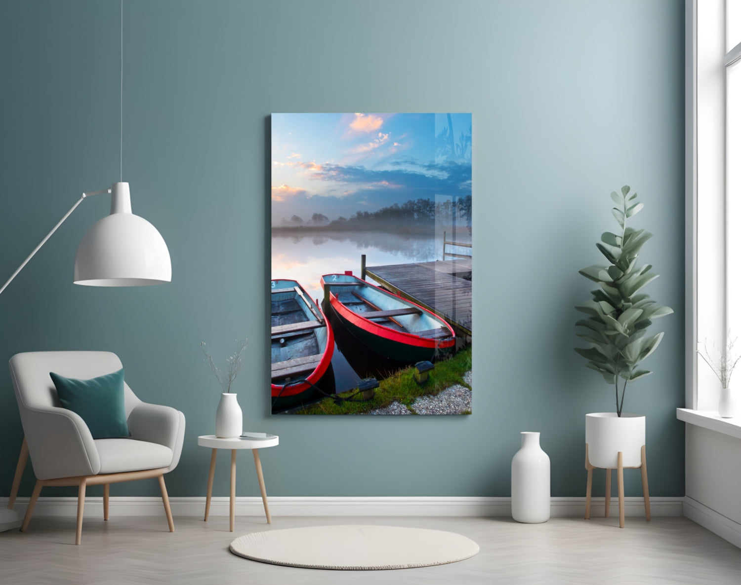 Glass wall art displaying red and blue boats on a misty lake at sunrise, hung in a contemporary room with teal walls.
