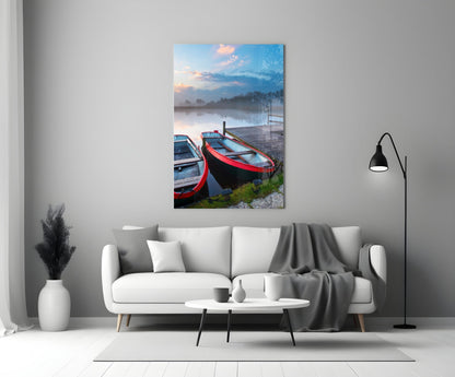 Glass wall art displaying red and blue boats moored at a wooden dock beside a misty lake at sunrise.