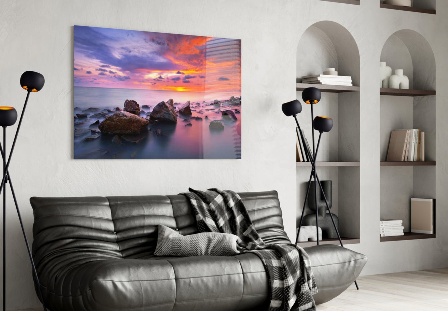 Sunset at Sea glass wall art displayed above a black leather sofa in a modern living room interior.