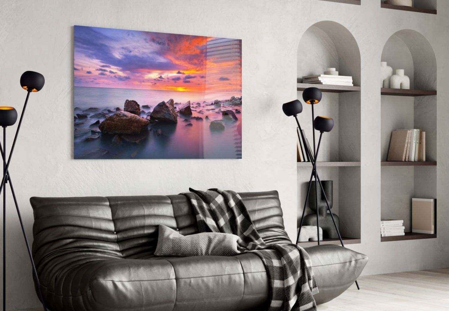 Sunset at Sea glass wall art displayed above a black leather sofa in a modern living room interior.