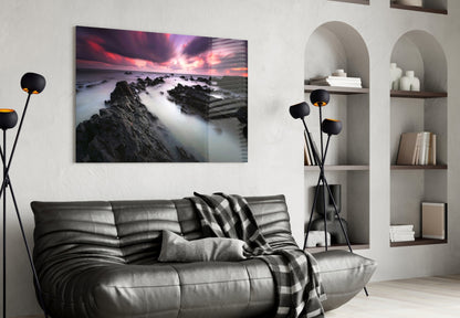 Crimson Sky Over Black Rocks Glass Wall Art