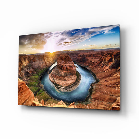 Horseshoe Bend glass wall art displayed at an angle, showing a river canyon landscape with red rock formations, blue water, and sunset sky.