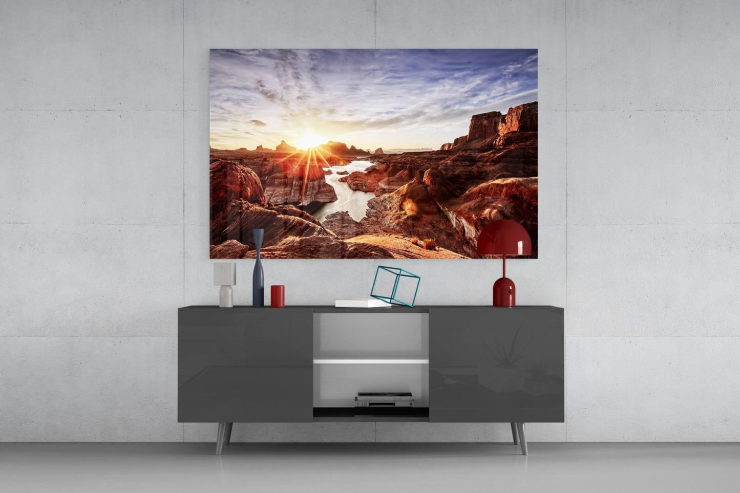 Canyon and Sunset Glass Wall Art hung above gray media console, displaying rocky landscape with sun rays and water reflections.