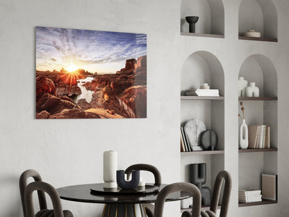 Canyon and Sunset Glass Wall Art displayed above a round black dining table in a modern interior with white built-in shelving.