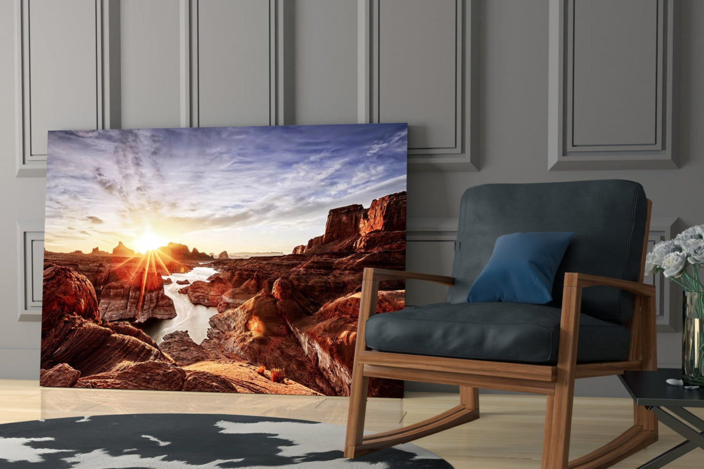 Glass wall art featuring a red rock canyon landscape with sunset, displayed in a modern living room beside a wooden-framed chair.
