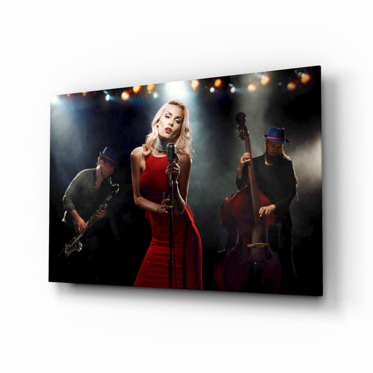 Glass wall art displaying a blonde female vocalist in a red dress singing at a microphone with a jazz band on stage.
