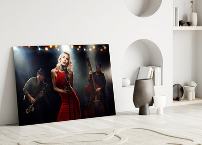 Glass wall art featuring a woman in red dress singing at microphone with saxophonist and bassist on stage.