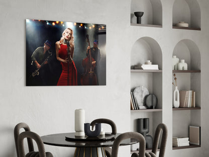 Glass wall art depicting a female jazz singer in a red dress performing with saxophone and bass players against stage lighting.