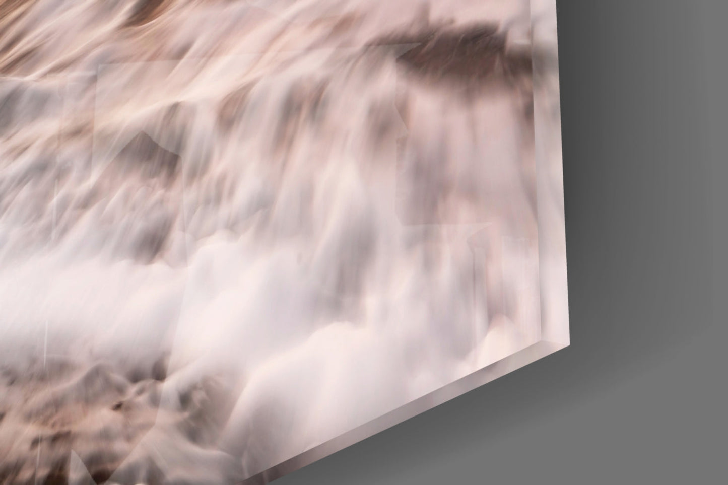 Close-up angled view of frosted glass panel showing white turbulent wave texture against gray background.
