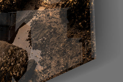 Close-up detail of textured glass wall art showing layered brown and gold tones with rusted metal surface effects and shadows.