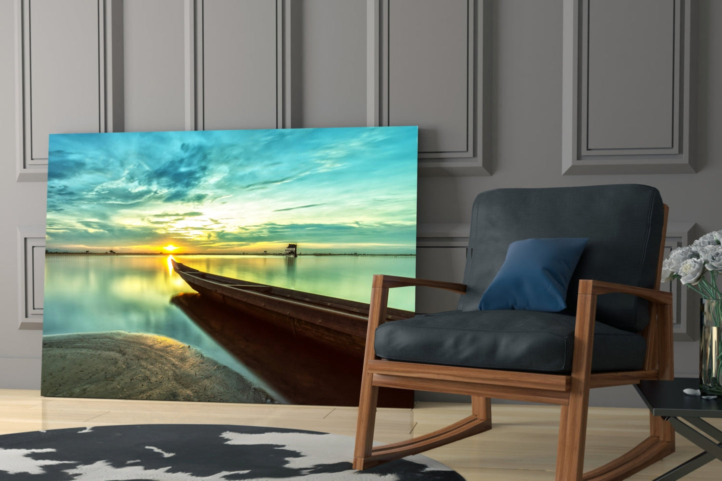 Glass wall art depicting a wooden kayak on sandy beach at sunset, displayed in a modern living room next to a wooden chair.