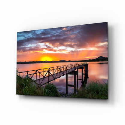 Fiery Sunset Lake Bridge Glass Wall Art
