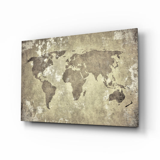 Angled perspective view of a beige glass wall art panel displaying a distressed vintage world map with brown continents and cream background.