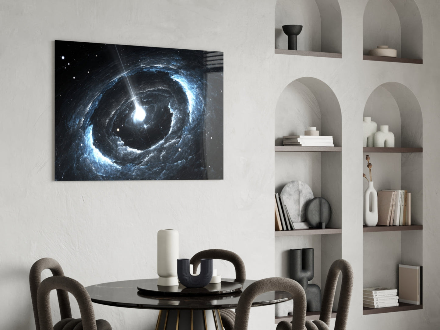 Blue and white spiral galaxy glass wall art hanging above a black dining table in a modern interior setting.