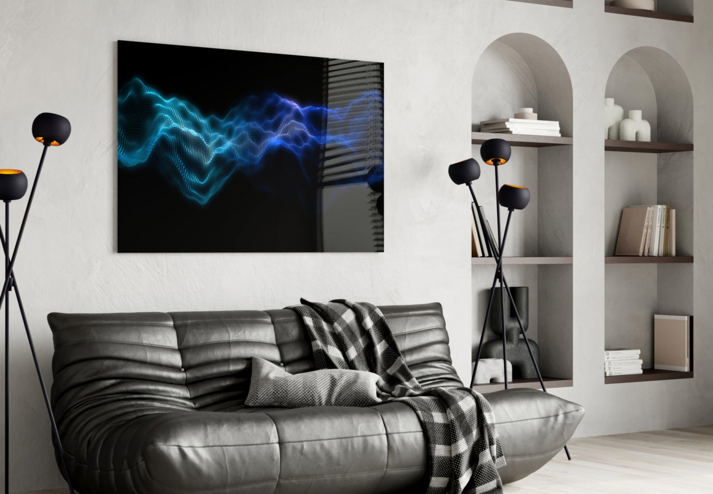 Modern living room with black leather sofa displaying blue glowing wave pattern glass wall art above it.