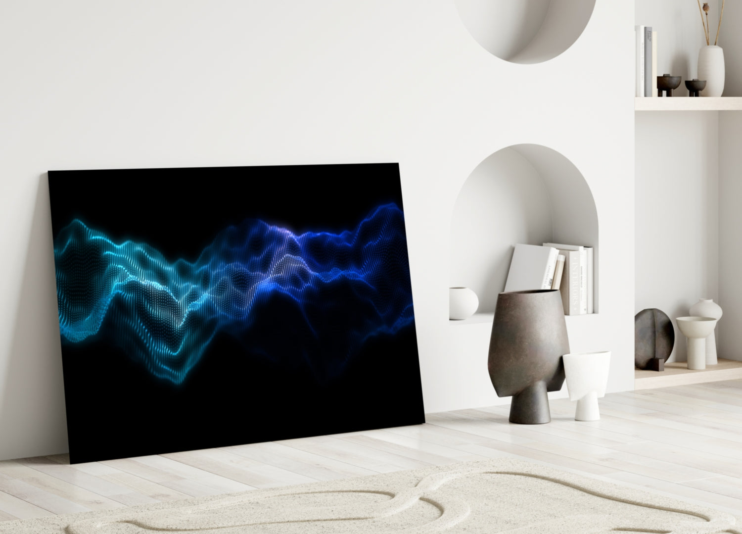 Glass wall art leaning against white wall displays flowing blue and cyan wave patterns on black background in minimalist interior.