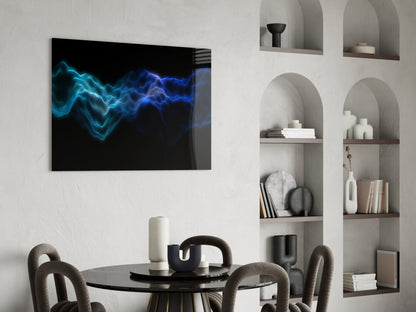 Modern dining room interior with Rhythmic Fog glass wall art displaying glowing blue wave patterns above round black table and curved gray chairs.