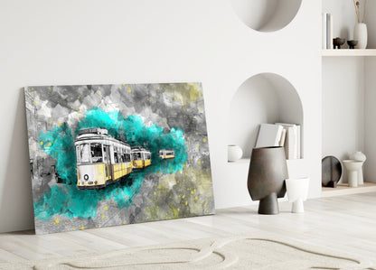 Glass wall art depicting yellow and white trams with turquoise watercolor splashes displayed leaning against white interior wall with shelving.