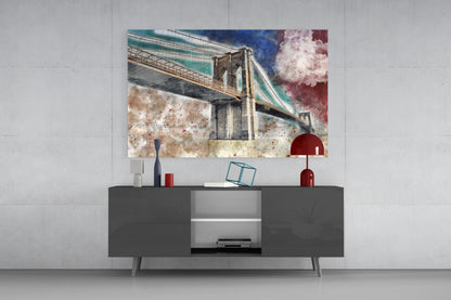 Colorful glass wall art depicting Brooklyn Bridge displayed above dark gray media console with red and blue decorative accessories.