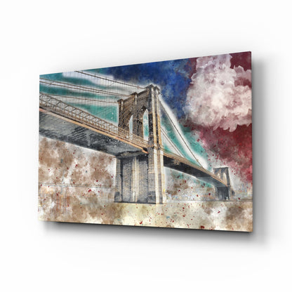 Glass wall art panel displaying a Brooklyn Bridge illustration with watercolor splashes in turquoise, burgundy, and cream tones.