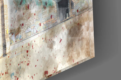 Close-up angled view of glass wall art showing textured surface with red and blue speckles on cream background, mounted panel detail visible.
