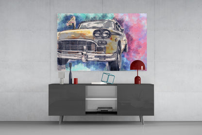 Colorful watercolor taxi illustration displayed on glass wall art above a dark modern console table in a minimalist interior setting.