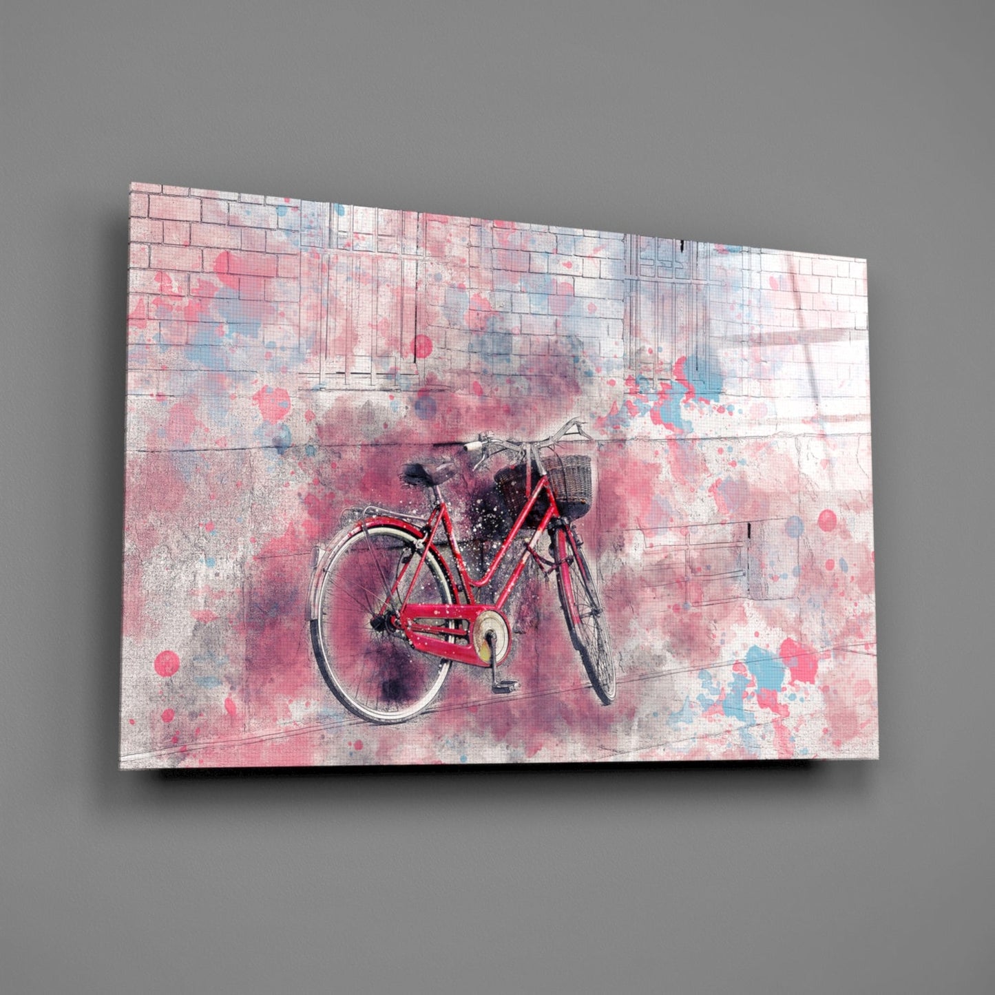 Red bicycle centered on pink and blue watercolor-splattered glass panel mounted on gray wall.